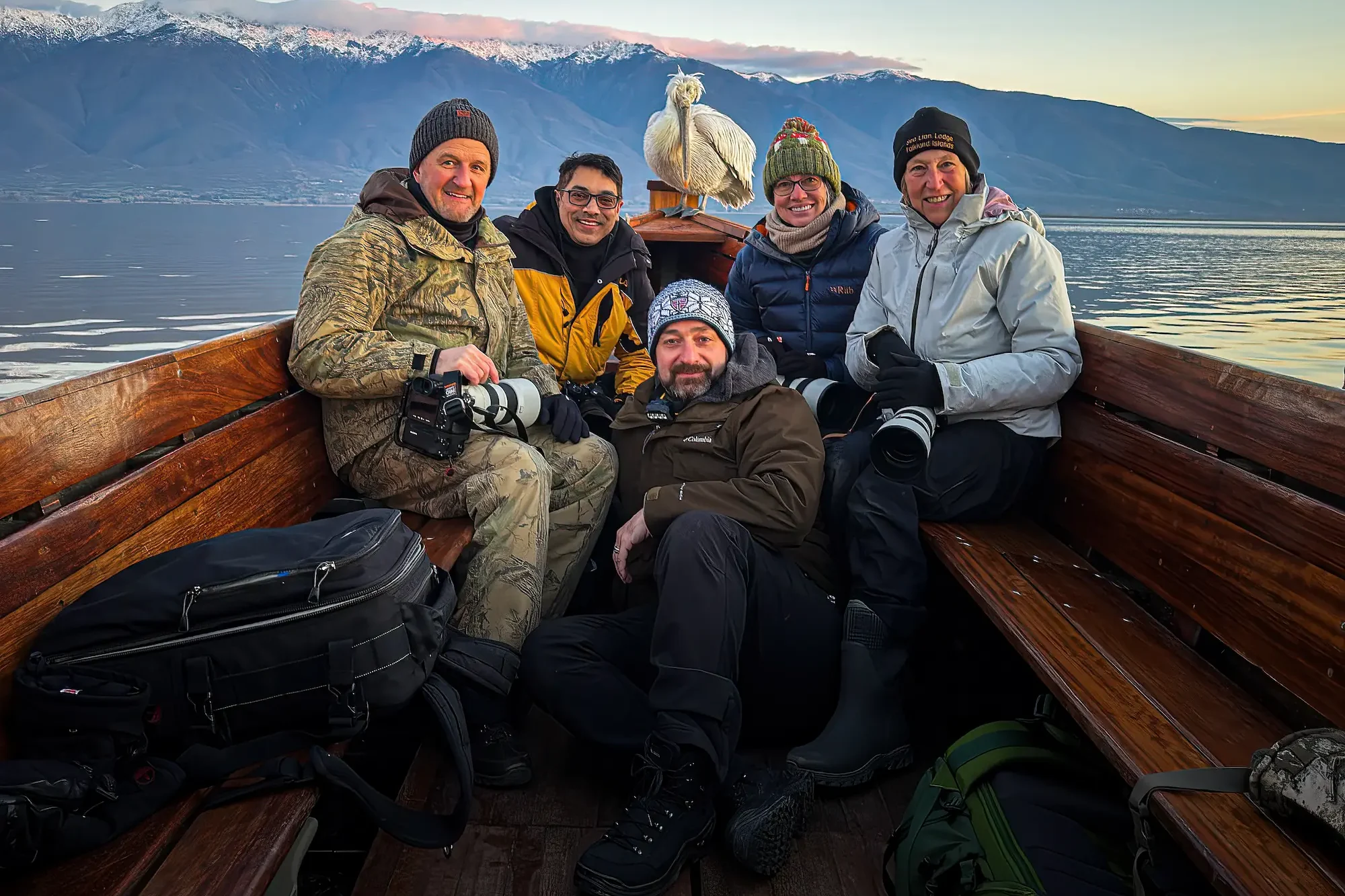 Lake Kerkini pelican workshop group on the boat Wildlife photography group on a boat at Lake Kerkini with a Dalmatian Pelican behind them